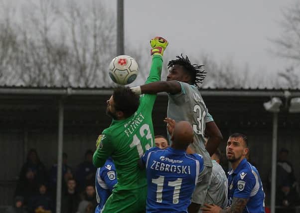 Tomi Adeloye battles for a high ball at Eastleigh.