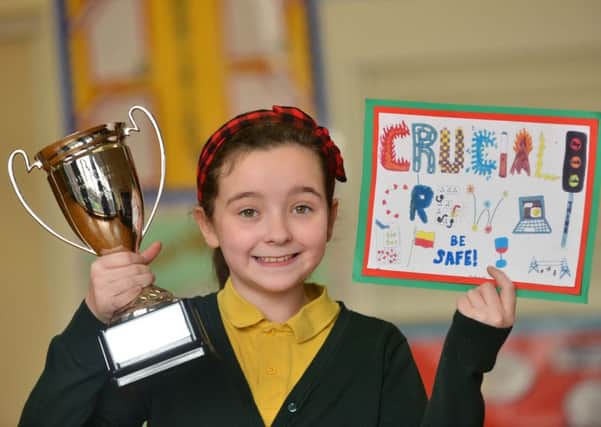 Crucial Crew winner St Joseph's Primary School pupil Mia Davison, 11, with her trophy and winning postcard design.