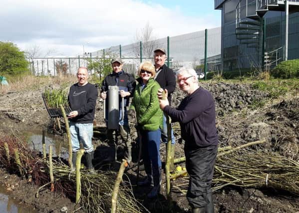 At Wapping Burn are, from left, Wear Rivers Trust secretary Neil Ashforth, local volunteer William Wilkinson, Sandra Wardle from Novus Business Centre , Jim Wood from Caterpillar, and local volunteer Gary Smith helping out with the final day wetland planting task.