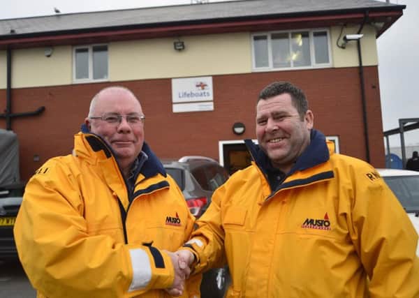 Mike Craddy (left) with the new lifeboats operations manager Chris Hornsey at the Ferry Road lifeboat station. Picture RNLI/Tom Collins