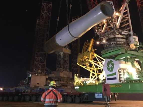 A monopile is lifted onto the installation vessel Innovation at Able Seaton Port.