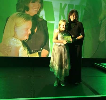 Jessica Stones is presented with her award by former 'Allo 'Allo star Vicki Michelle.