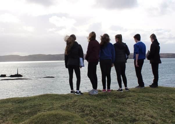 Pupils from the Nicolson Institute look out to sea where the Iolaire sunk in 1919.
