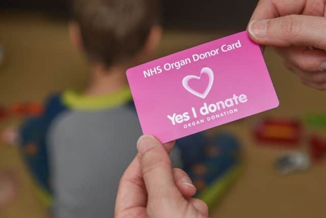 "Yes I donate" NHS organ donor card. Card in hand.