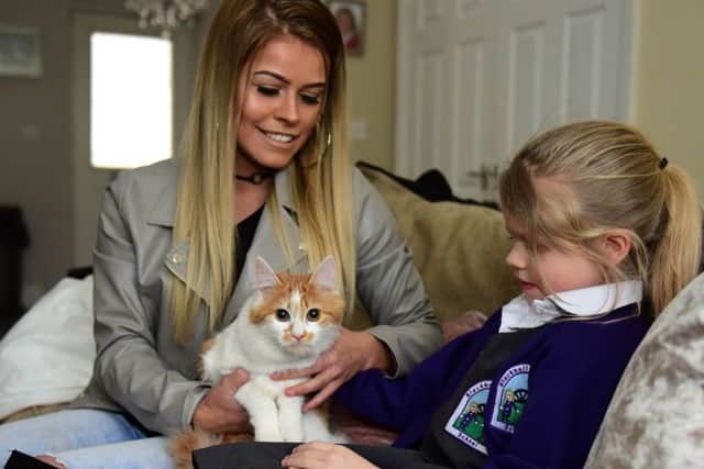 Kitten Gracie is pleased to be home with owner Samantha Chandler and her daughter, six-year-old Leah Barnett.