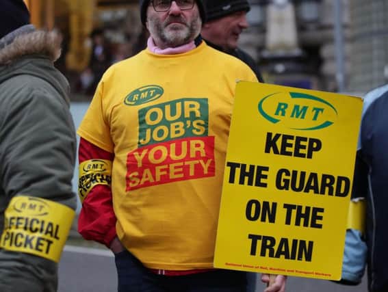 An RMT member taking part in a previous strike day. Pic: PA.