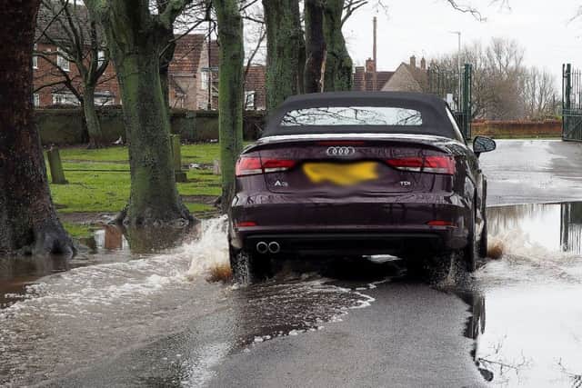 A car driving through standing water in Stranton cemetery. Picture by FRANK REID