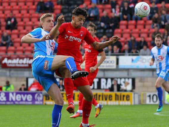 Michael Ledger challenges for possession in this season's clash at Leyton Orient.
