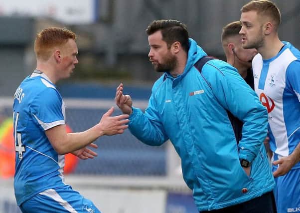 Hartlepool caretaker manager Matthew Bates gives instructions to Michael Woods.