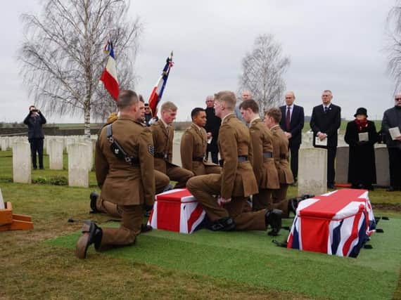 Members of the 3 Rifles Regiment prepare to lower the coffin of the unknown Durham Light Infantry soldier.