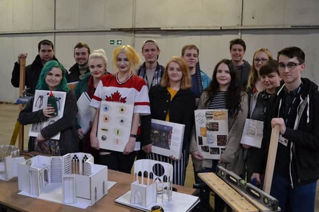 Production Design students with the set models and artwork.