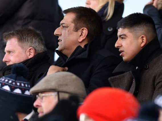 Raj Singh (centre) watches Hartlepool United in action alongside former Pools boss Craig Hignett, who is set to return as director of football should the takeover be completed.