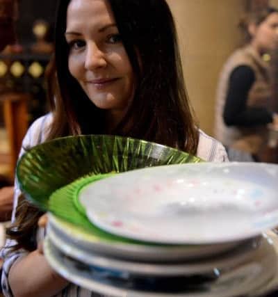 Andrea Thubron carries dirty dishes from the soup kitchen through St Aidans Church. Picture by Frank Reid