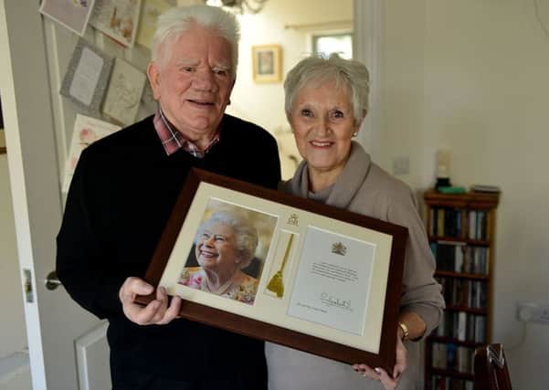 Dorothea and Peter Harker with their framed card from The Queen on the occasion of their Diamond Wedding. Picture by Frank Reid