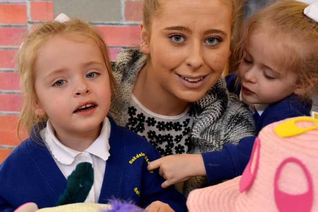 Eskdale Academy pupils, twins Faith (left) and Hope Brazil, three, with their mum Demi Thompson, 21, after making their Easter Bonnets.