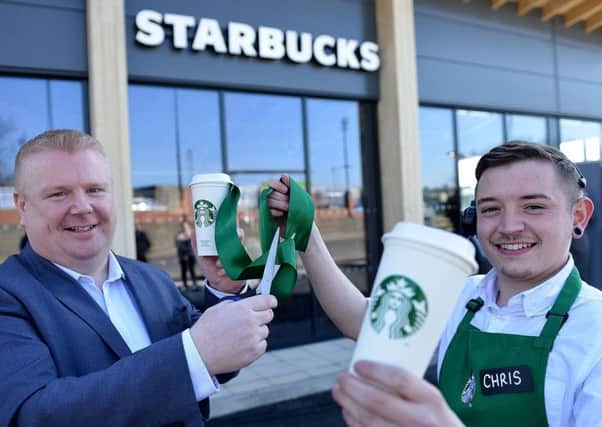 Paul Thompson, manager of Families First North East and Starbucks manager Chris Nash cut the ribbon to open the new Starbucks. Picture by Frank Reid