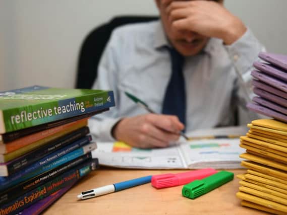 The NUT section of the National Education Union has claimed eight in 10 teachers have considered leaving the profession because of their heavy workloads. Pic: PA.
