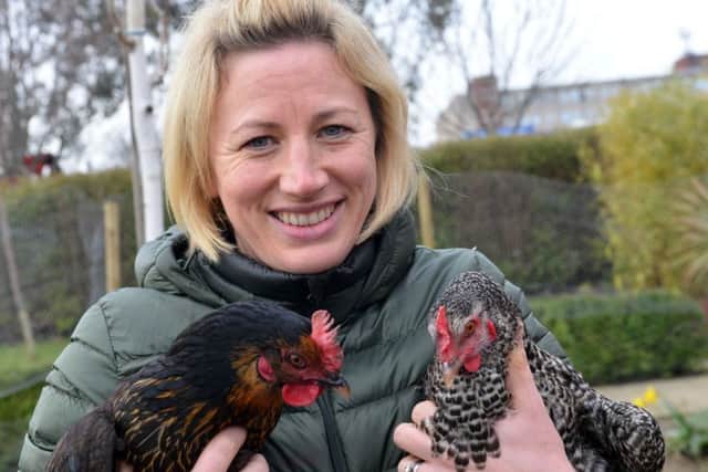 Alice House Hospice fundraising manager Rebecca Jobson with hospice chickens Paxo and Martha.