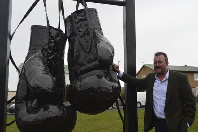 Graeme Hopper pictured with the statue he created.