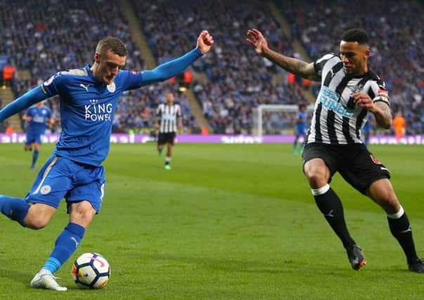 Jamaal Lascelles tries to block out Jamie Vardy