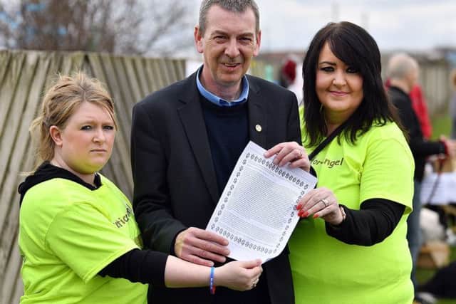 Hartlepool MP Mike Hill was presented with a scroll with Angel's story on it by Justice for Angel group members Jenna Davies, left, and Lynn Williamson, right, during the Justice for Angel event held at Mainsforth Terrace.