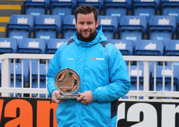 Matthew Bates with his manager of the month award. Picture: HUFC.