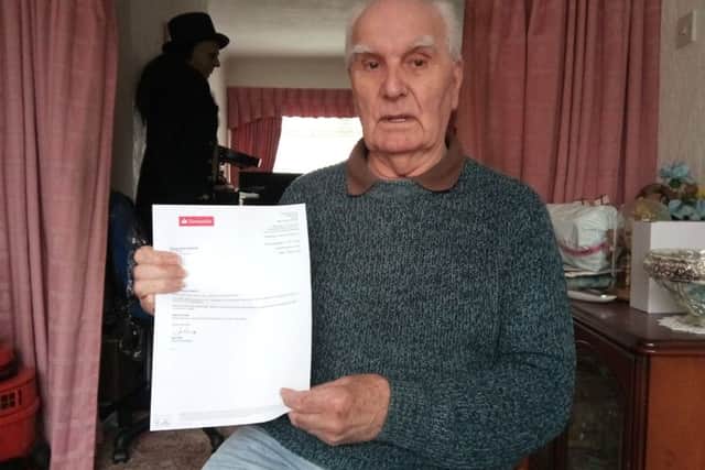 George McKie holding a letter from his bank Santander after his fraud.