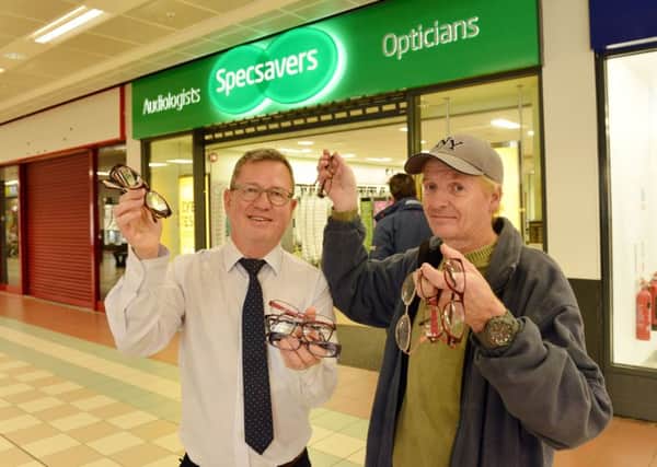Ian Walker (Director of Specsavers) gives a donation of spectacles to Michael Stalley. Picture by Frank Reid