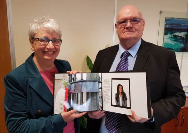 Edwin Jeffries presents a pictorial record of last years Workers Memorial Day Remembrance Service created by photography graduate Elle Cain to Hartlepool Borough Council Chief Executive Gill Alexander.