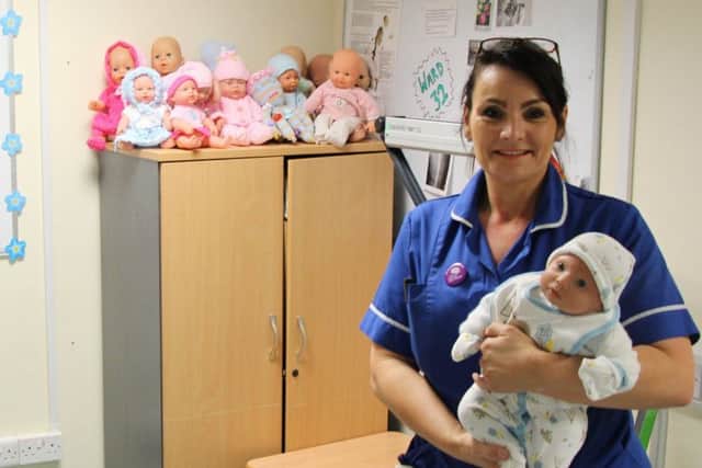 Michelle Wild with some of the dementia dolls.