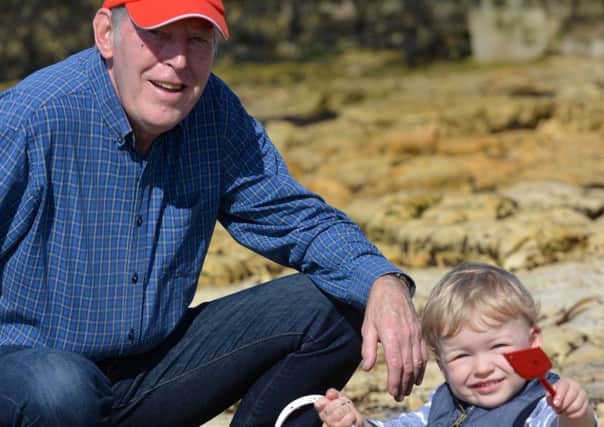 Sun and high temperature on Hartlepool's Headland. Youngster James Skinner, three, with grandfather Peter Cook.