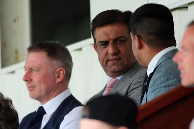 New Pools owner Raj Singh, centre, at today's game after his takeover was finally confirmed.
