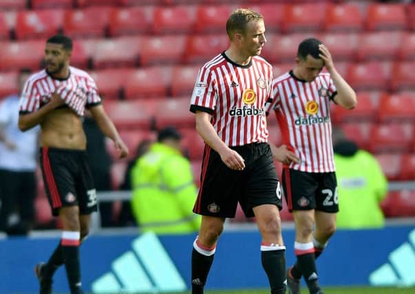 Dejected Sunderland players make their way off the pitch at the end of their game against Burton Albion.