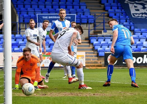 Rhys Oates turns in Pools' second goal at Tranmere.