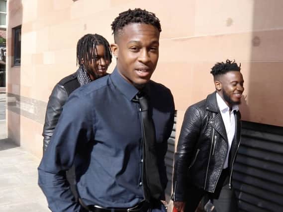 Newcastle United footballer Rolando Aarons (navy blue shirt, dark tie) arrives at Newcastle Crow Court this morning, where he faces charges relating to an incident at a popular Newcastle city centre bar. Picture by North News.