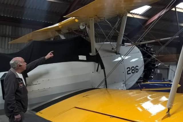 Tom inspects the bi-plane at Breighton Airfield near Selby