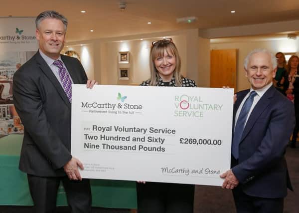 David Bridges, group sales and marketing director for McCarthy and Stone presents the cheque to Catherine Johnstone, chief executive officer of the Royal Voluntary Service and Wayne Sleep.