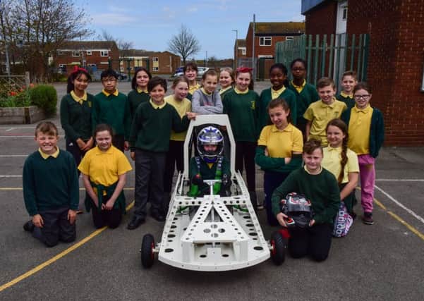 Pupils at St Joseph's RC Primary School, Hartlepool, watch the first run of their green energy car, that they helped to build