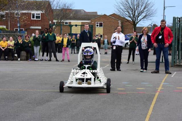 Pupils at St. Joseph's RC Primary School, Hartlepool, watch the first run of their green energy car, that they helped to build