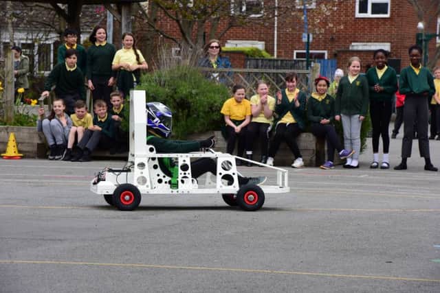 Pupils at St. Joseph's RC Primary School, Hartlepool, watch the first run of their green energy car, that they helped to build