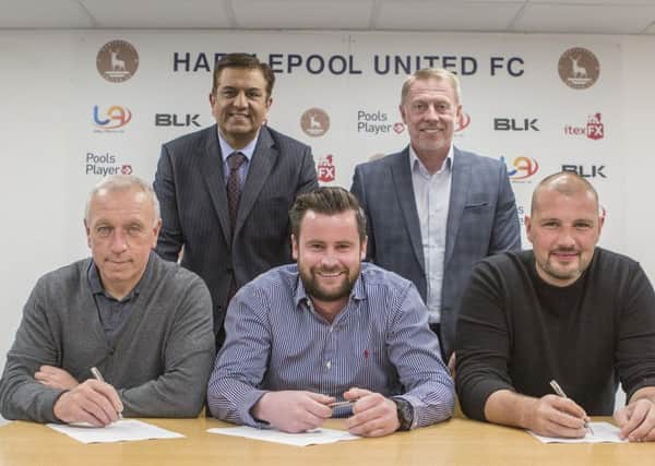 Ged McNamee, Matthew Bates and Ross Turnbull sign up at Hartlepool United watched by Raj Singh and Craig Hignett