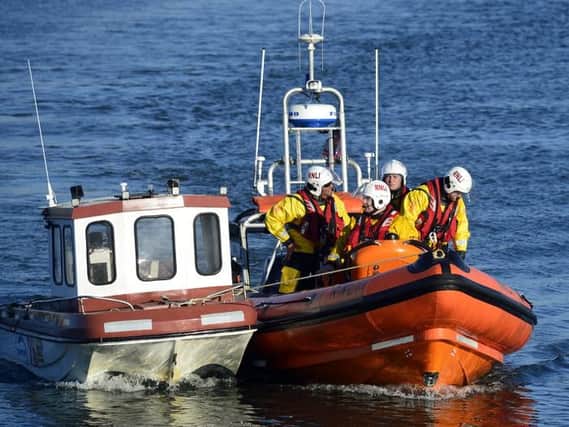 Hartlepool RNLI inshore lifeboat and volunteer crew pictured with the two casualties during the incident.