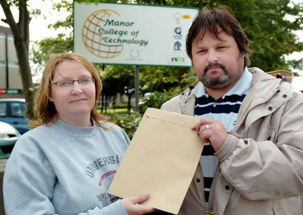 Dawn and Ian McManus with their son Kyle's GCSE exam results after they collected them from Manor College of Technology following his death.