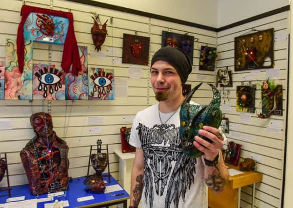 Danny Short and some of the masks he has made, now on display at The Artrium, Middleton Grange Shopping Centre, Hartlepool.