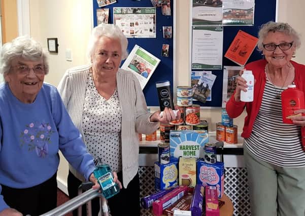 Queens Meadow Care Home residents (from left) Betty McGeorge,
Jean Walker and Betty Wilson with some of the donations for the St Aidans Church foodbank.