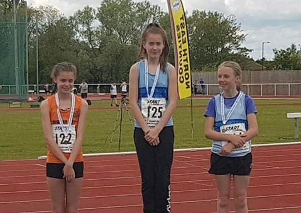 Emma McNeil, middle, following her win with runner-up Zoe Hill of Middlesbrough AC and Freya Gibson, left, third place of Durham City Harriers.