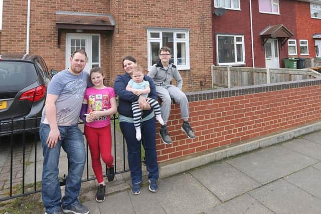 Mike Holland and Lindsey Harrison and their children Faith, 10,  Aria, one, and James, 11, outside their Hartlepool home