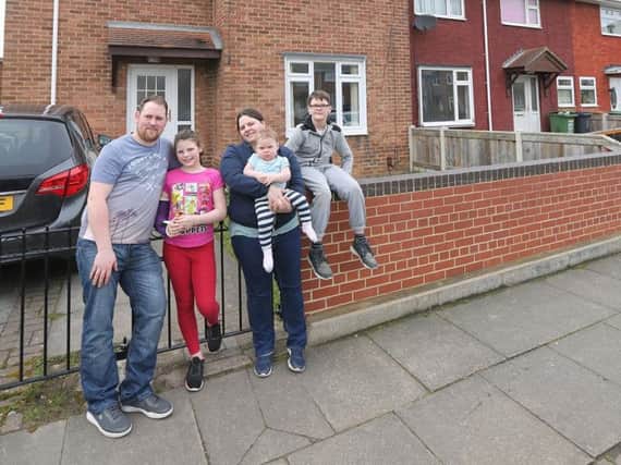 Mike Holland and Lindsey Harrison and their children Faith, 10,  Aria, one, and James, 11, outside their Hartlepool home
