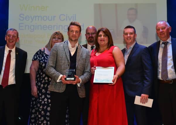 Overall Business of the Year winner Seymour Civil Engineering, with MP Mike Hill (left) and Michael Bretherick (right) Chief Executive Gus Robinson Foundation at the  Hartlepool Business Awards 208 at the Borough Hall, Hartlepool, last night.