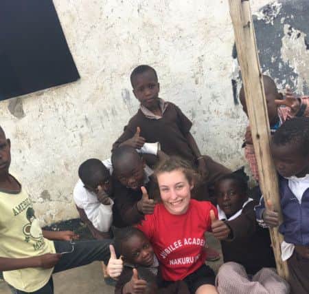 Ellie Lewis with some of the children she met on her trip.